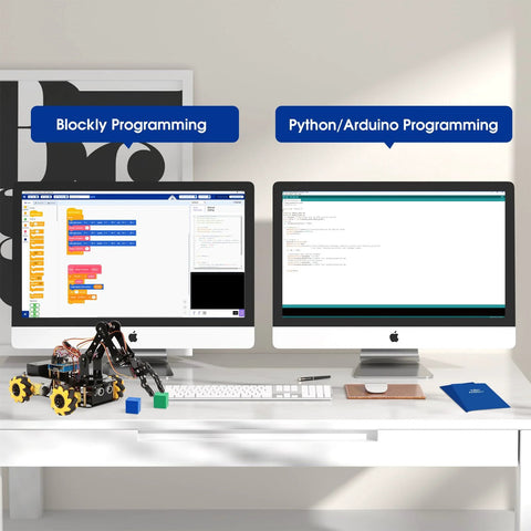 ACEBOTT robot arm expansion pack on a desk with two iMacs displaying Blockly and Python programming interfaces