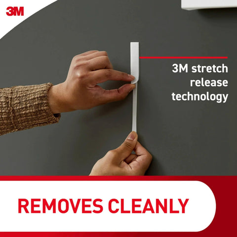 Demonstrating 3M stretch release technology for clear variety pack for damage free hanging, shows easy strip removal from wall