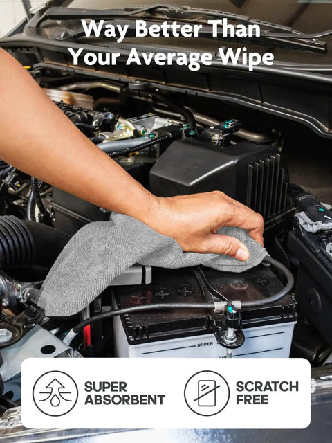 Hand using Ultra Absorbent Microfiber Cloth Roll Tear Away Towels 12x12 Pink Grey Reusable to clean car engine battery.