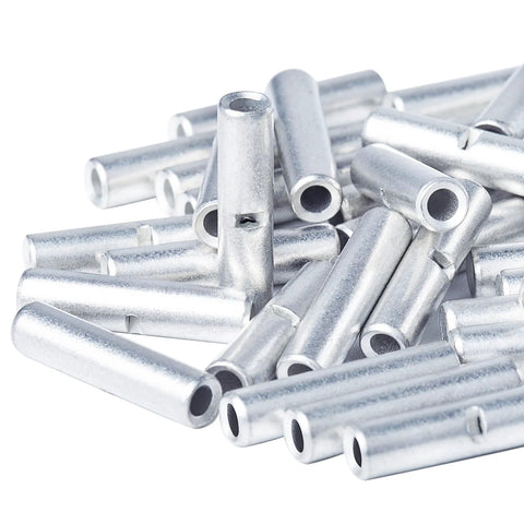 Pile of uninsulated butt connectors for 22-16 AWG wiring; silver metal crimp terminals.
