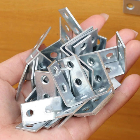 Hand holding 10 Pieces Iron Right Angle Corner Brackets For Furniture Cabinets Tables And Chairs Connectors Fasteners Hardware Accessories
