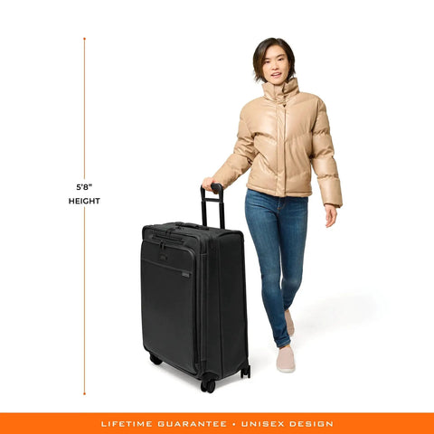 Woman pulling Large 29 Inch Expandable Spinner Checked Luggage For Travel With One Touch CX Compression And Four 360 Spinner Wheels Softside Rolling Bag For Men And Women Self Repairing Zipper Baseline Collection Black Briggs And Riley
