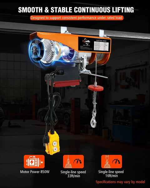 Front view of orange electric hoist winch mounted to a ceiling beam with wired yellow remote and hook
