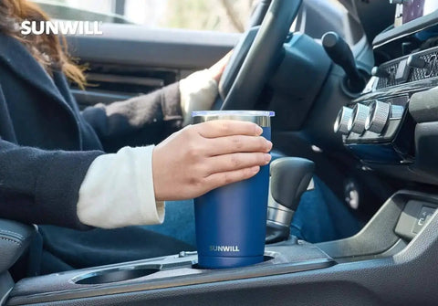 Person holding 20 Oz Travel Coffee Tumbler Insulated Stainless Steel Cup With Lid in car, navy blue powder coated, double wall vacuum