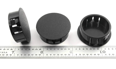 Black Nylon Hole Plugs For 1 1/8 Inch Holes With Locking Tabs, shown with ruler for scale, 6 Pack