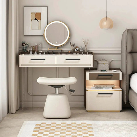 Vanity desk setup with drawers and stool in a modern bedroom