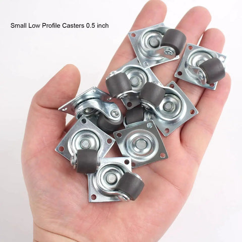 Hand holding eight 0.5 Inch Mini Swivel Caster Wheels with Self Adhesive Plate Low Profile Rubber Casters for Furniture and Small Kitchen Appliances