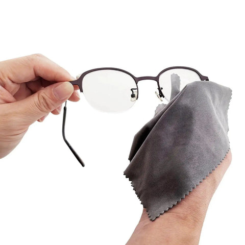 Cleaning glasses with gray microfiber cloth from 30 Pack Lint Free Microfiber Cleaning Cloths for Glasses Lenses and Screens