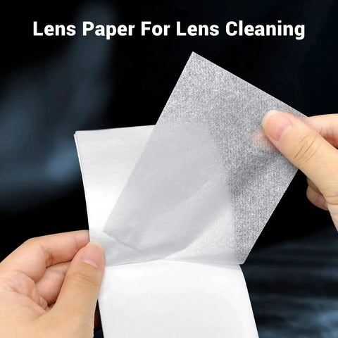 Hands holding 700 Sheets Lens Cleaning Tissue Paper for Microscopes and Camera Lenses booklet, displaying individual sheet