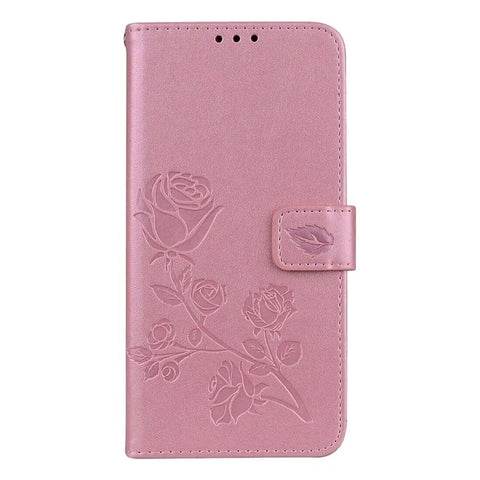 Pink leather phone case with embossed rose design and magnetic clasp.