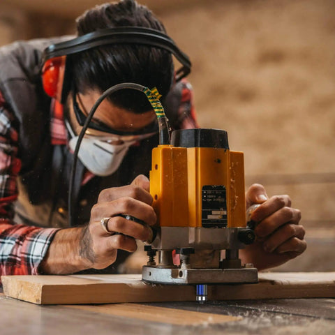 Person using router with Pro Straight Flush Trim Router Bit Set With Top Bearing, 1/4 Inch Shank, C3 Carbide Blades and Alloy Steel Bodies