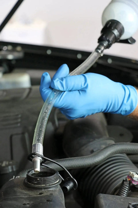 1.5 Liter Fluid Evacuator And Dispensing Syringe With Twist Valve ATF Adapter in use during automotive fluid transfer