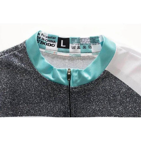Close-up of a size L black and white sports jacket with turquoise collar detail showing care instructions label.