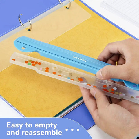 Blue 3 Ring Hole Puncher For Binders with detachable waste tray held over an open binder, featuring plastic and stainless steel construction.