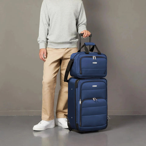 Man with Softside Luggage Set With 23 Inch Expandable Wheeled Suitcase And 15 Inch Tote For Work Trips And Weekend Getaways Extra Space Plus Front Pockets Smooth Rolling Dual Wheels Telescopic Handle Navy Blue By Amazon Basics