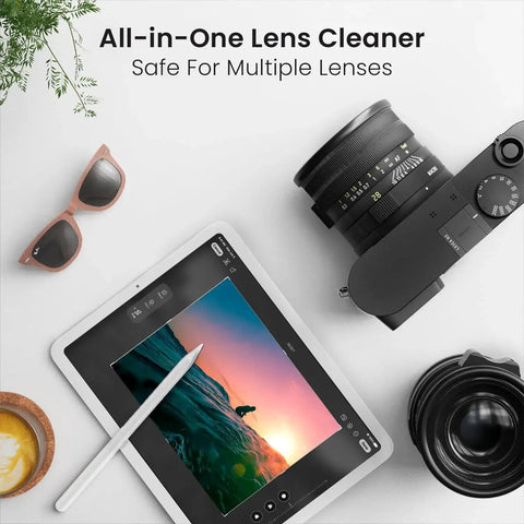 Streak-Free Glasses Cleaner Spray Kit With 2 Bottles And 2 Microfiber Cloths shown with a camera, tablet, and sunglasses on a table.