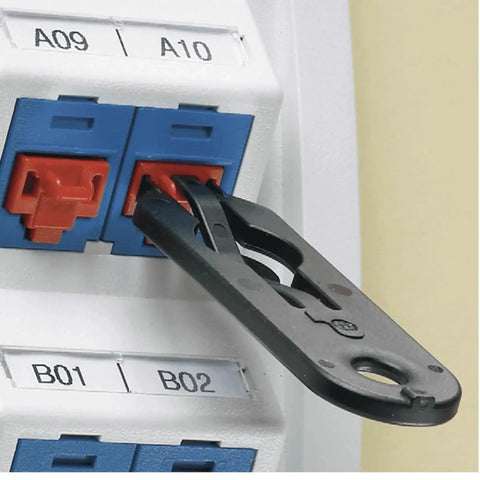 RJ45 Jack Blockout Device Kit With 10 Black Blockouts And Removal Tool, close-up view of tool removing blockout from port