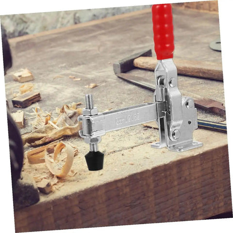 Fixed Toggle Clamp Set With Rubber Tips on a woodworking bench, showcasing iron construction for precise fastening.