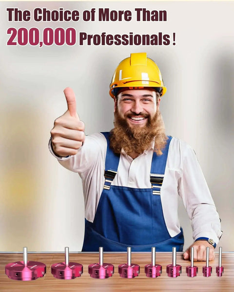 Worker in yellow hard hat and blue overalls giving a thumbs up beside a set of drill attachments on a table.