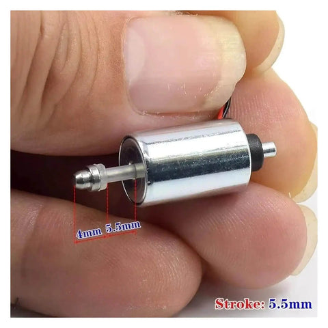 Mini Round 10mm Solenoid Electromagnet With 7.4V 9V 12V DC, Suction Push Pull Type held between fingers, showing 5.5mm stroke