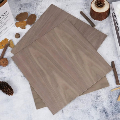 12 Pack Walnut Unfinished Wood Sheets 12 x 12 x 1 Eighth Inch 3mm Thick For Laser Cutting And Engraving CNC Routing Fretwork Painting Wood Burning And DIY School Projects stacked on a textured surface.