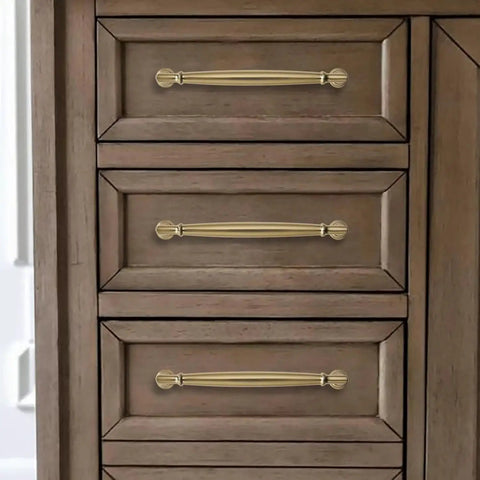 5 Inch Brushed Brass Cabinet Pulls 10 Pack installed on wooden drawers, showcasing heavy duty solid warm gold handles for cabinets and cupboards.