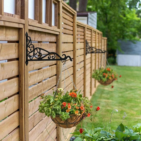 Hanging flower baskets on a wooden fence in a garden