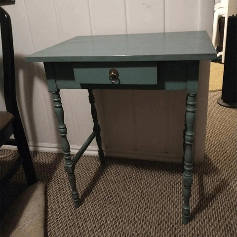 A wooden table with a drawer, featuring a Vintage Style Brass Ring Pulls For Cabinets And Drawers.