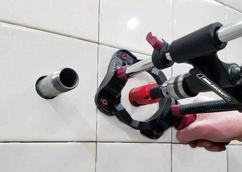Drilling with Portable Drilling Guide Attachment for straight and angled holes in tile wall, fits 3/8 and 1/2 inch drills.