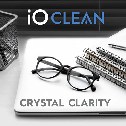 Eyeglass Lens Cleaner Spray Kit For Glasses And Screens With 2 Microfiber Cloths on desk with eyeglasses and notebooks