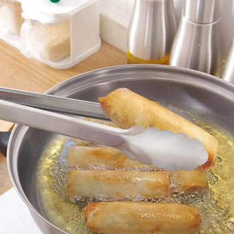 Two Pack 9 Inch And 12 Inch Stainless Steel Kitchen Tongs With Locking Mechanism in use, lifting food from frying pan
