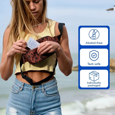Woman at beach holding Alcohol Free Hearing Aid Cleaning Wipes 100 Pcs Individually Packaged from her bag
