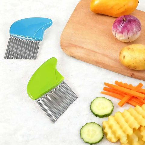 Two Pack Crinkle Cutter Set For Potatoes And Vegetables Stainless Steel Waffle Fry Cutters For Making Waffle Fries Carrot Chips And More Durable Kitchen Knife With Safe PP Handle In Green And Blue on kitchen counter with sliced vegetables.
