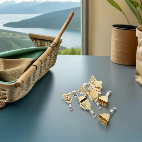 Stainless Steel Fishing Rod Bite Alarm Bells With Clips 15 Piece Set on table with fishing rod and view of lake through window