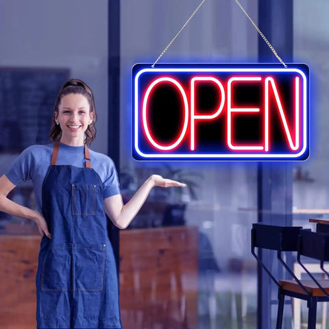Person standing beside 16.5 X 9 Inch Led Neon Open Sign For Business Ultra Bright Plug In Light Up Open Sign With Blue Red Backplate.