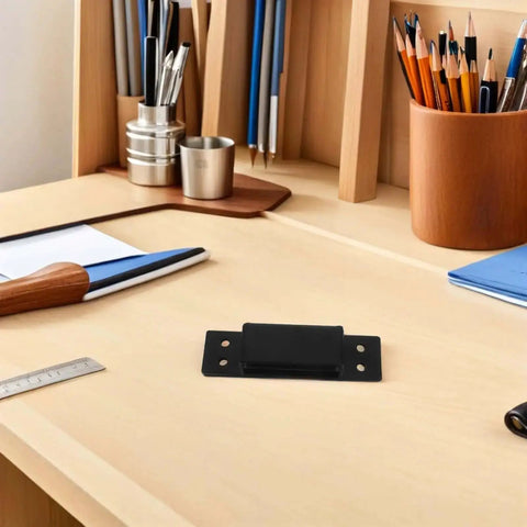 Hidden Door Hinge 5 Inch Black Concealed Pivot for Cabinets and Secret Doors sitting on a wooden desk