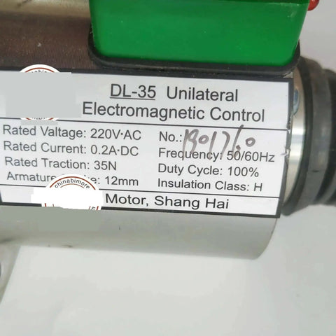 Close-up of AC220V Escalator Brake Electromagnet Spare Part label with specifications and manufacturing details