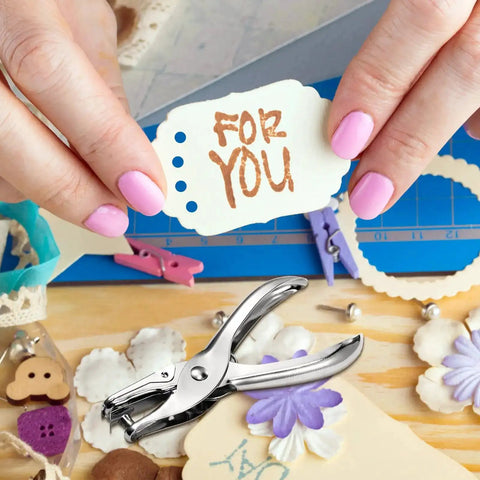 Close-up of 24 Pack 1/4 Inch Single Hole Punch Set Metal Paper Puncher used for card making, surrounded by crafts and gift tag 'For You'
