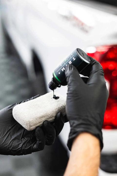 Applying Trim And Exterior Plastic Restorer With UV Protection Up To 2 Years 50 Ml on cloth for car trim