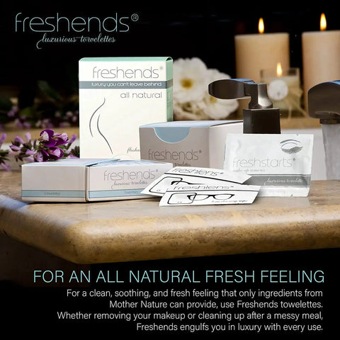 Assorted Freshends luxury towelettes and packaging on a bathroom counter with candles, promoting a natural fresh feeling.