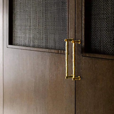 Gold Brass Bamboo Shape Cabinet Handles Set, Antique Brushed Copper Finish, installed on wooden cabinet doors.
