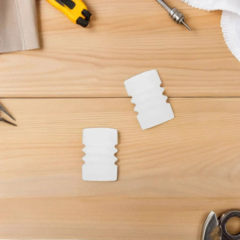 Two pieces of the Silicone Sealing Gasket Set With Wave Sleeves, 4 Piece Replacement Kit For Ice Cream Makers on a wooden table.
