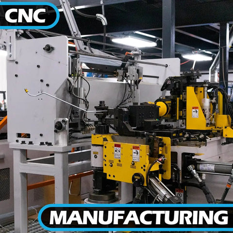 CNC manufacturing machine with yellow control panel and metal framework on factory floor.