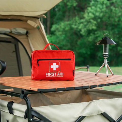 Outdoor scene showing the Grab And Go All Purpose First Aid Kit For Home And Office Ready For Emergencies With Thermometer Ice Packs Burn Gel.