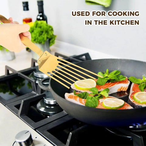 High Heat Stainless Steel Slotted Spatula For Frying And Turning With Non Slip Ergonomic Handle Works Like A Champ Heavy Duty Fish Turner In Gold Finish For Kitchen Use Snailhouse being used to fry fish in a pan.