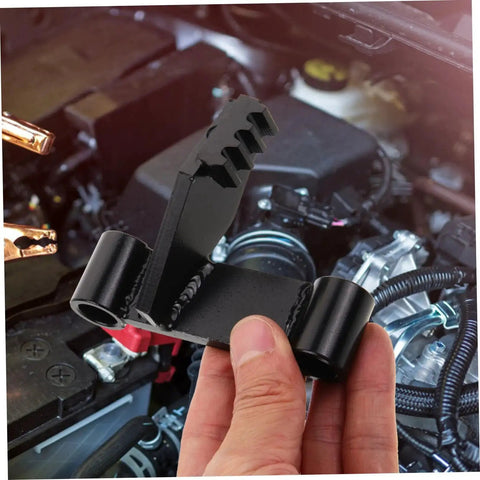 Black metal flywheel holding tool for automotive engines; toothed end and locking bracket.