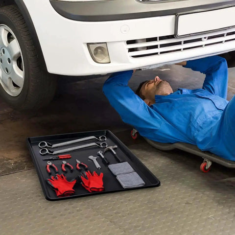 Mechanic under car with Triple Pack Extra Large Oil Drip Pan 35.4 X 24 Inch Heavy Duty Plastic Drain Tray for Car Maintenance