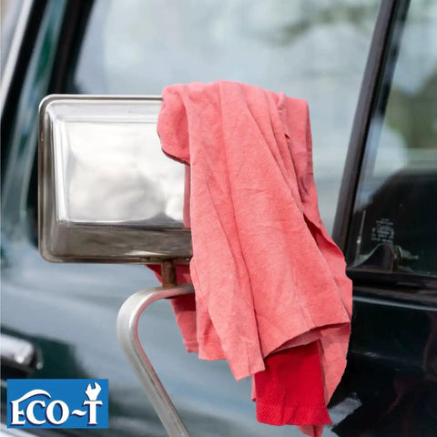 Industrial Mechanic Shop Rags Four Pound Bag Made From 100 Percent Recycled Colored T Shirt Material resting on car mirror
