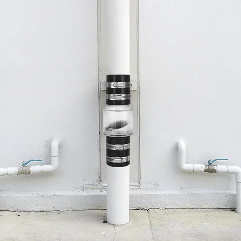QWORK CV-150 silent check valve with clear body on vertical PVC pipe, 1-1/2 in, Buna-N couplings and steel clamps