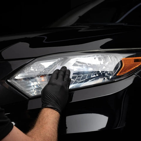 Close-up of Long Lasting Ceramic Headlight Restoration Kit application on car headlight for clarity.